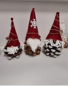 three christmas gnomes made out of pine cones