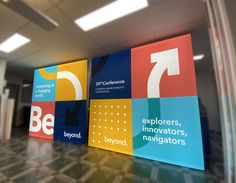 an office lobby with colorful signage on the wall and tile flooring that says be beyond