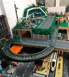 a lego model of a city with cars and buildings