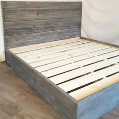 a bed frame made out of wood with no headboard or foot board on it