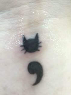 a black cat tattoo on the side of a woman's stomach