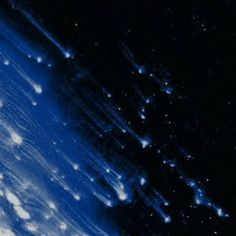 an abstract blue and black background with white dots on the bottom right corner, as seen from space