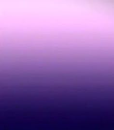 an airplane flying in the sky with purple and blue hues