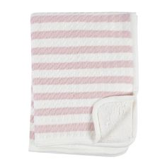 the pink and white striped blanket is folded up