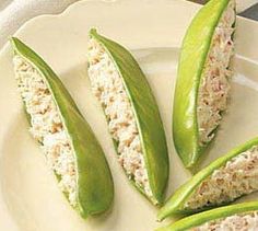 some green beans are on a white plate with rice and peas in it, ready to be eaten