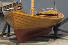 a wooden boat sitting on top of a pier