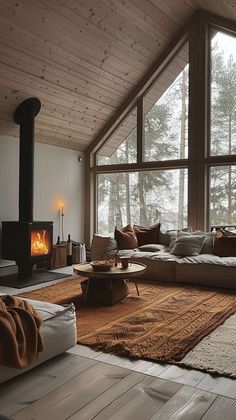 a living room filled with furniture and a fire place in front of a large window