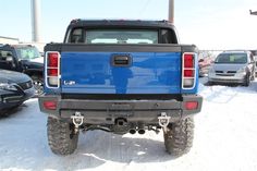 a blue pick up truck parked in the snow