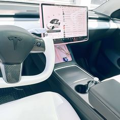 the interior of a car with an electronic device in it's center console and dashboard