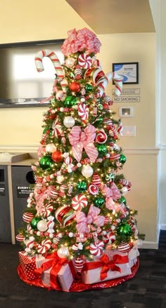 a christmas tree decorated with candy canes and bows