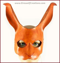 This transformative Brown Rabbit mask is handmade from a single piece of vegetable-tanned leather and dyed light brown, with details on the eyes and nose carved into the leather and painted dark red. You have two size options: Big Bunny and Mini Bun. Big Bunny's nose goes past the nose of the wearer by about an inch (2.5cm) or so, and the ears are about 6 inches (15.25cm) long. Mini Bun's nose goes just past the wearer's, and the ears are about 4.5 inches (11.4cm) long. If you want to be able to eat and drink while wearing your mask, Mini Bun is the way to go. Pictures of the "Mini Bun" design can be seen alongside the Big Bunny for a size comparison in the photos of the Black Rabbit. You can also see the Mini Bun design in the last photo, which was graciously shared by my wonderful custom Bunny Mask Halloween, Halloween Masquerade Costume, Leather Masks, Pirate Eye, Rabbit Mask, Mini Bun, Pirate Eye Patches, Brown Rabbit, Bunny Mask