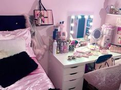 a bedroom with a vanity, mirror and lights on it's sides is seen in this image