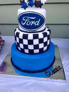 a blue and white cake with ford logo on it