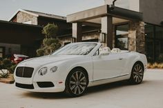 a white car parked in front of a building