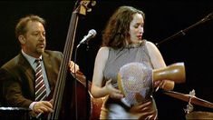 a man and woman playing musical instruments on stage