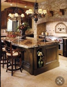 a large kitchen with an island and chandelier in the center, along with two bar stools