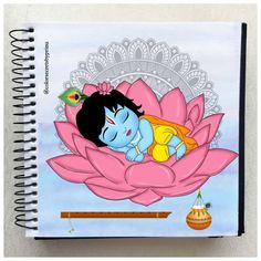 a spiral notebook with an image of a little boy sleeping on a lotus flower in the middle