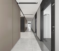 an empty hallway with white walls and black doors