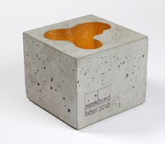 a concrete block with an orange substance in it's center on a white background