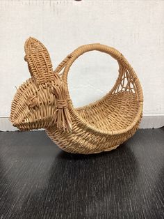 an empty wicker basket sitting on top of a wooden table