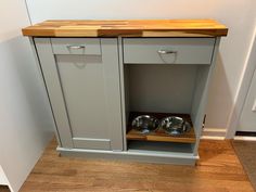 an empty cabinet with two bowls in it