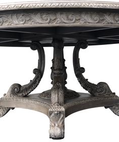 an ornately decorated table with silver paint on the top and bottom, against a white background