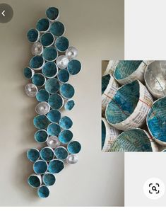 there are many bowls on the wall and one is blue with silver balls in it