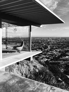 a black and white photo of a house overlooking the city