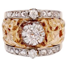 Ring in 18 karat yellow gold, eagle head hallmark. Sublime antique band ring, it is decorated in the center of an antique cushion-cut diamond surmounted on both sides of a double line of 2x4 rose-cut diamonds, centered on an antique cushion-cut diamond of more important size, retained with claws. The ring is pierced, engraved and chiseled all around with arabesque patterns and two chimeras that enclose the main diamond in their claws. The ring is numbered on the outside 2132. Total weight of the main diamond : 0.30 carat approximately. Total weight of the other diamonds : about 0.18 carat. Height : 15.5 mm, height at the base : about 8.1 mm, thickness : about 5.5 mm. Total weight of the jewel : 11.4 g approximately. US Size : 5. No resize. Authentic antique jewel - Work of the second half Antique Cushion Cut Diamond, Antique Cushion Cut, Antique Cushion, Arabesque Pattern, Gold Eagle, Eagle Head, Cushion Cut Diamonds, Rose Cut Diamond, Arabesque