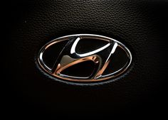 the front emblem of a car on a black leather surface