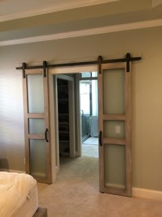 an empty bedroom with sliding glass doors leading to another room