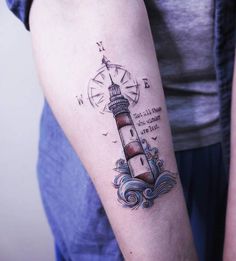 a person with a small lighthouse tattoo on their arm