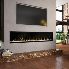 a modern fireplace with a flat screen tv above it and wood flooring in the background