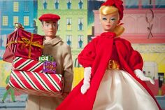 two dolls dressed in red and white carrying presents