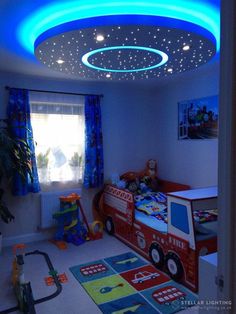 a child's bedroom decorated in blue and red with a firetruck theme