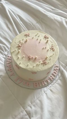 a birthday cake sitting on top of a white blanket