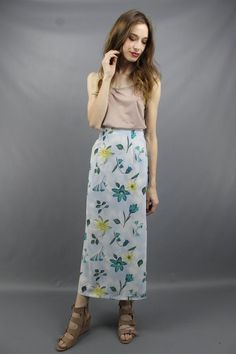 Vintage nineties BLUE FLORAL MAXI SKIRT. Partial elastic waist. Back zipper + button. 17 inch slits on both sides.Model is 5'9. Her measurements are: bust=34 inches, waist=26 inches, & hips=34 inches. The skirt fits as shown on her.We measure on a flat surface from seam to seam. Bust, waist, & hip measurements have already been doubled. We suggest you compare our measurements to a garment you already own and know fits you well to ensure a proper fit.label: rikki j new york approximate si Spring Maxi Skirt With Relaxed Fit, Fitted Pencil Maxi Skirt For Summer, Blue Summer Pencil Skirt, High Waist Floral Print Maxi Skirt In Relaxed Fit, High Waist Relaxed Floral Maxi Skirt, Flowy High-waist Spring Maxi Skirt, Flowy High Waist Spring Maxi Skirt, High Waist Fitted Wrap Skirt For Spring, Blue Midi Pencil Skirt For Summer