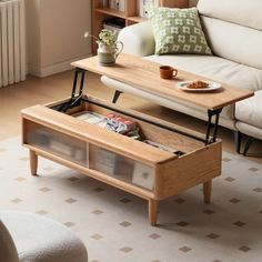 a living room with a couch, coffee table and bookshelf on the floor