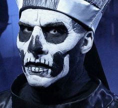 a close up of a person wearing a skeleton makeup and headdress on their face