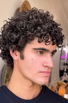 This hairstyle showcases tightly wound, bouncy curls that are carefully sculpted to create a full, voluminous look, beautifully framing the face. The slightly longer length on top adds depth and texture, allowing the natural curl pattern to shine through. Perfect for men who want to embrace their natural curls, this cut - Click to see more of 30 Stylish and Modern Curly Hairstyles for the Discerning Gentleman and follow us for more hairstyle ideas. // Photo Credit: Instagram @urbanbloomcurls Short Curly Hair For Guys, Men's Curly Hairstyles Short Curls, Curly Hair Men Medium Length, Modern Curly Hairstyles, Butterfly Haircuts, Mens Short Curly Hairstyles, Short Curly Cuts, Medium Short Haircuts