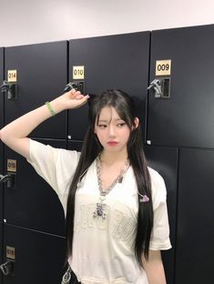 a young woman standing in front of lockers