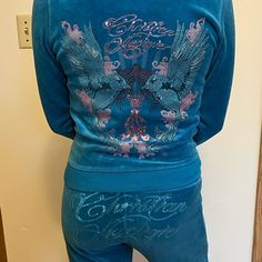 the back of a woman's blue pajama set with an eagle on it