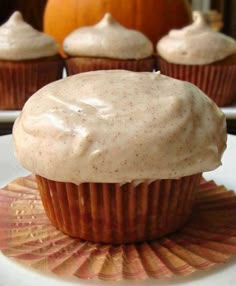 cupcakes with frosting sitting on a plate