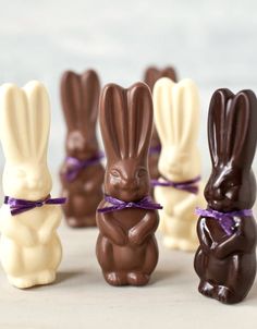 chocolate bunnies in the shape of rabbits tied to each other with purple ribbon around them