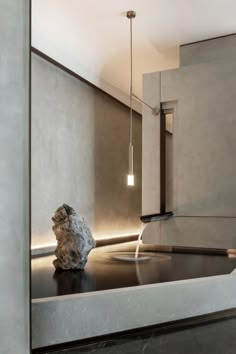 a large rock sitting on top of a counter next to a light hanging from the ceiling