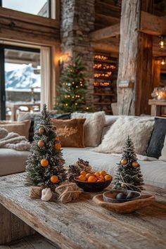 a living room filled with lots of furniture and christmas tree decorations on top of a wooden table