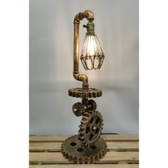 an old fashioned steam engine table lamp with a light bulb on it's side