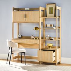 a wooden desk and chair in front of a book shelf with shelves on each side