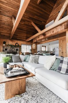 a living room filled with furniture and wooden walls