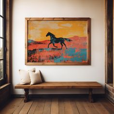 a wooden bench sitting in front of a painting hanging on the side of a wall